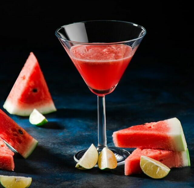 a watermelon martini garnished with a slice of watermelon