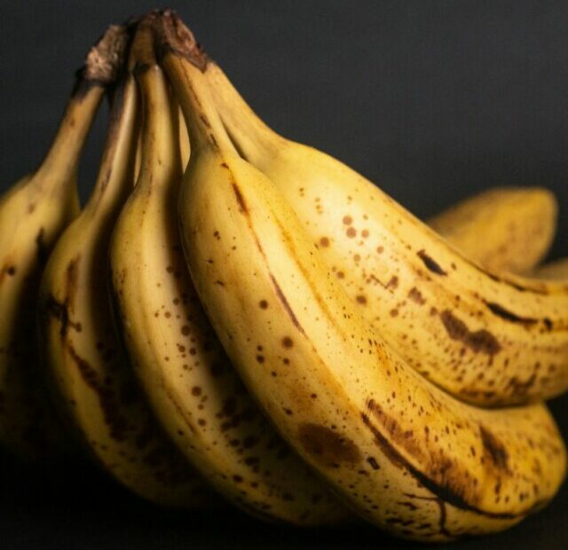 yellow banana fruit on black textile