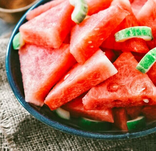 sliced watermelon on black round plate