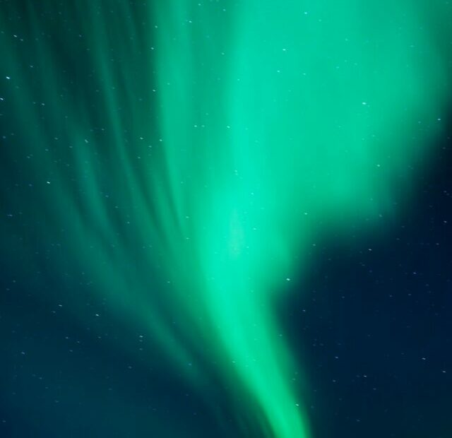 a green aurora bore in the night sky